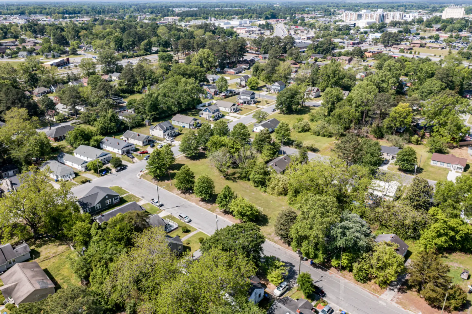 Aerial view of a residential neighborhood of single-family homes and tree-lined streets